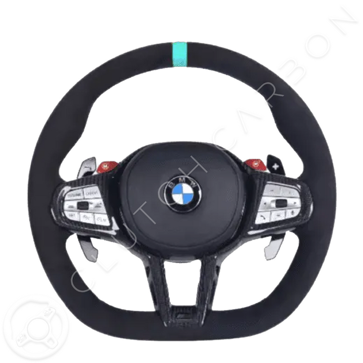 The BMW G-Series LCI Custom Carbon Fiber Steering Wheel features black upholstery, red and silver buttons, sleek metallic paddle shifters, a turquoise stripe at the top center, and a subtle CLUTCH CARBON watermark on the white background.