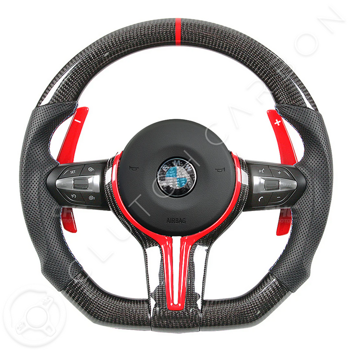 The BMW F-Series Custom Carbon Fiber Steering Wheel is a sleek black and red design with intricate details, featuring gear shift paddles, control buttons, and a distinctive central emblem.