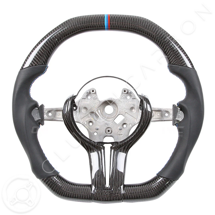 The BMW F-Series Custom Carbon Fiber Steering Wheel features an offset center and sporty design with a glossy finish, highlighted by a small blue and red stripe on top for a dynamic look.