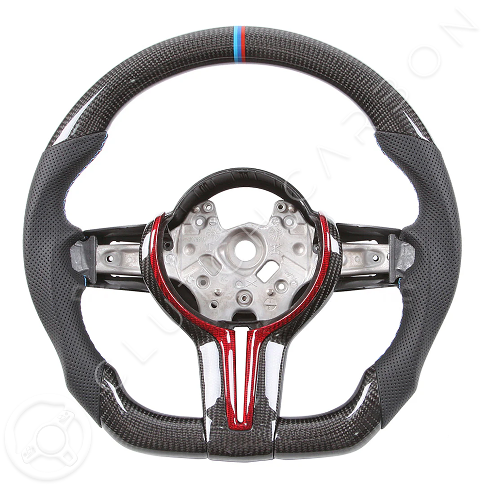 The BMW F-Series Custom Carbon Fiber Steering Wheel features a sporty design with red and blue accents, a perforated grip for enhanced handling, and a central mount for easy attachment.