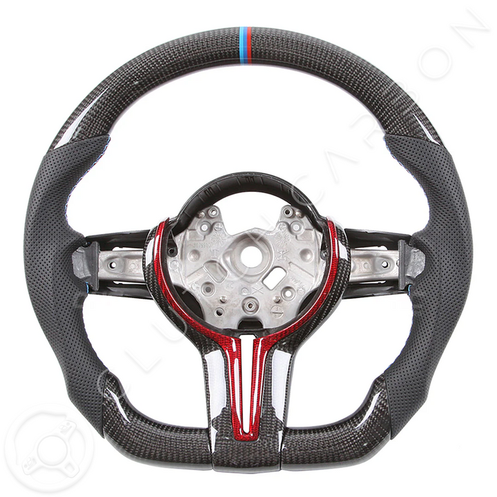 The BMW F-Series Custom Carbon Fiber Steering Wheel features a sporty design with red and blue accents, a perforated grip for enhanced handling, and a central mount for easy attachment.